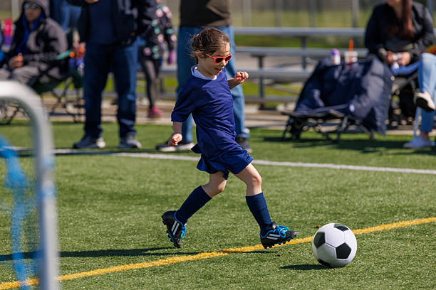 istock Little girl having fun playing soccer game. 2212820956