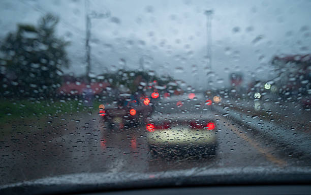 istock Rain drop on the car glass window while driving on the road. 2212823748