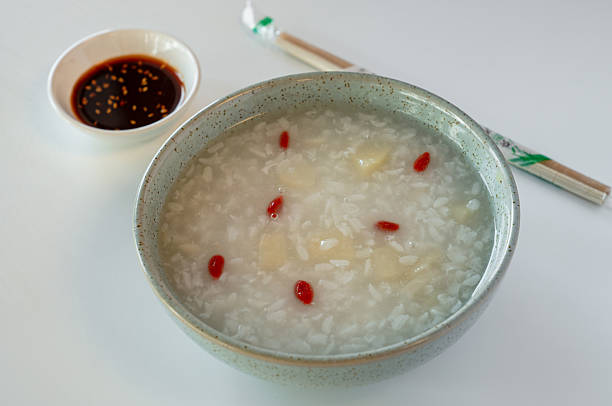 Nutritious wolfberry and barley porridge isolated against white background.
