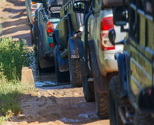4wd vehicle driving through mud at speed.