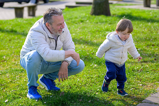 istock Grandfather Watching Toddler Explore 2212842312