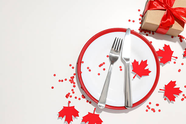 istock Cutlery with a gift and maple leaves on a light background 2212842552