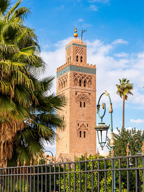 istock Koutoubia Mosque minaret in Marrakesh, Morocco, surrounded by palm trees under bright blue sky, showcasing historic Islamic architecture, cultural heritage, religious significance and vibrant scenery. 2212843378