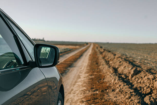 istock Rear view mirror in car on field, travel concept 2212843828