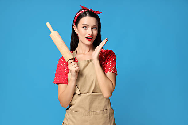 A girl, a housewife, with utensils for cooking.