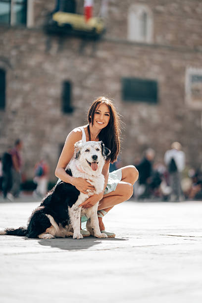woman doing the caress to her cute dog