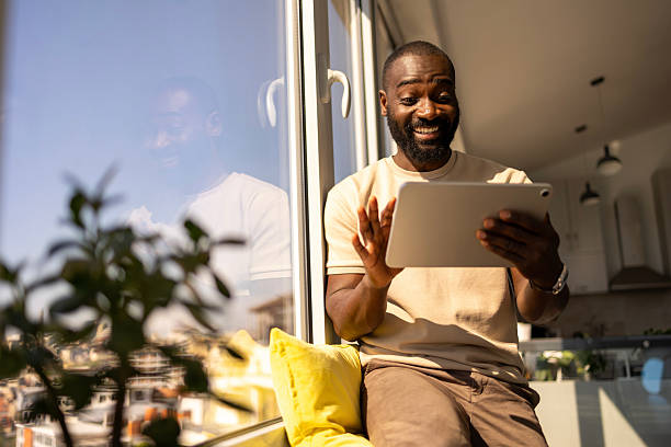 istock Person enjoying a digital tablet indoors with natural sunlight 2212847656