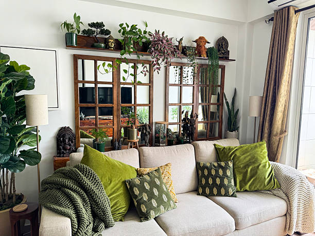 Image of stylish living room with beige chaise settee / cozy lounge seating, window pane mirrors, decorative shelf stock photo