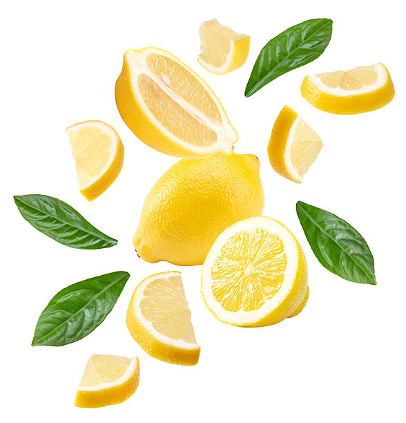 istock flying lemon with leaves isolated on white background. clipping path 2212848608