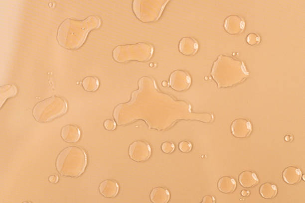 istock Water droplets on beige fabric 2212851569