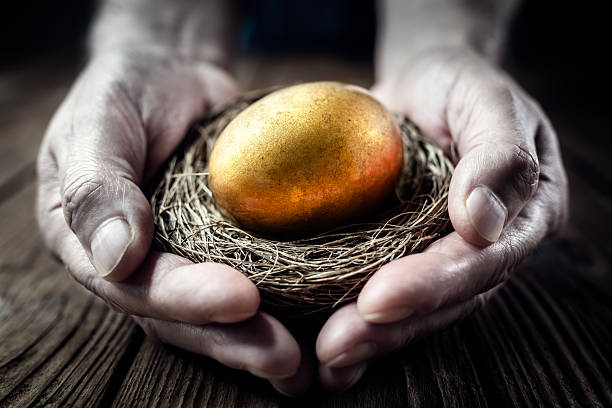 istock Retirement savings golden nest egg in mans hand 2212854148
