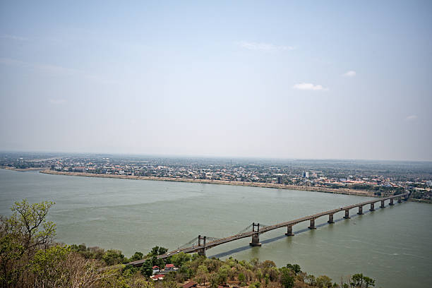 From the top of Wat Phousalao in Pakse, Laos, a remarkable panorama unfolds, capturing the very essence of the city. In April 2025, the soft morning light caresses the colorful rooftops and bustling streets, creating a subtle play of shadows and reflections. This view from the temple allows one to observe the astonishing fusion of traditional architecture and touches of modernity that punctuate the urban landscape. On the horizon, the Mekong River meanders peacefully, accentuating the serenity that emanates from the whole. Historic buildings and recent structures coexist harmoniously, testifying to the cultural richness and dynamic evolution of Pakse. Lush vegetation surrounds the city, bringing an essential natural touch to this urban setting. This privileged vantage point invites contemplation, meditation, and escape, offering visitors a moment suspended between past and future, tradition and modernity. Each element of this scene tells a story, making this panorama a true invitation to travel and discover Laos authentically.