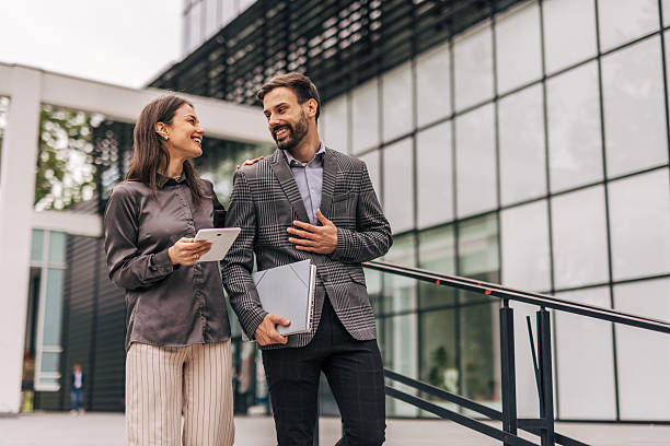 istock Business partners walking and talking outside office building 2212856388