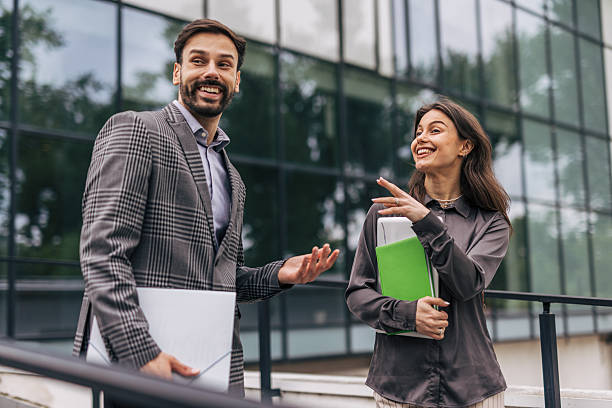 istock Business colleagues exchanging ideas outside office building 2212858024