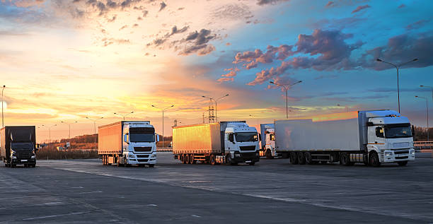 istock Trucks in parking lot on suburban highway 2212859596