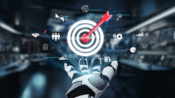 istock Futuristic Robot Hand Reaching Out Toward a Target with Digital Icons Representing Business, Technology, and Innovation Concepts in a Modern Environment. Auvana 2212860214