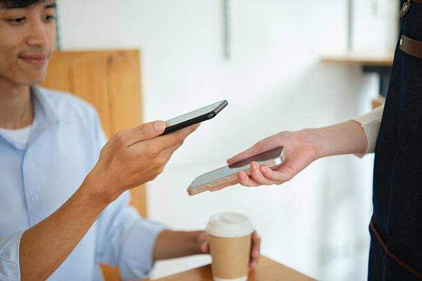 istock Customer making digital payment at coffee shop using smartphone. 2212860333