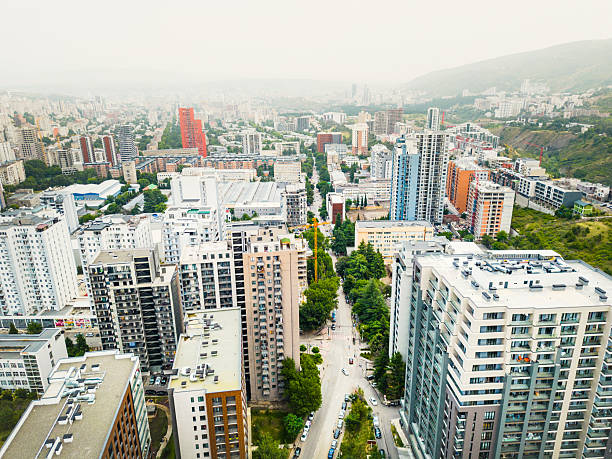istock Aerial rising view construction site with crane cary block material and workers working. Real estate site in Saburtalo, Tbilisi, Georgia 2212860410