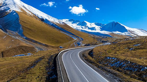 istock Aerial view  on the road surrounded by winter Landscape view 2212860475
