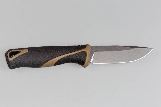istock Fixed tourist knife on a gray background, top view 2212860799