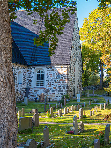 istock Historic stone church and graveyard in autumn 2212861122