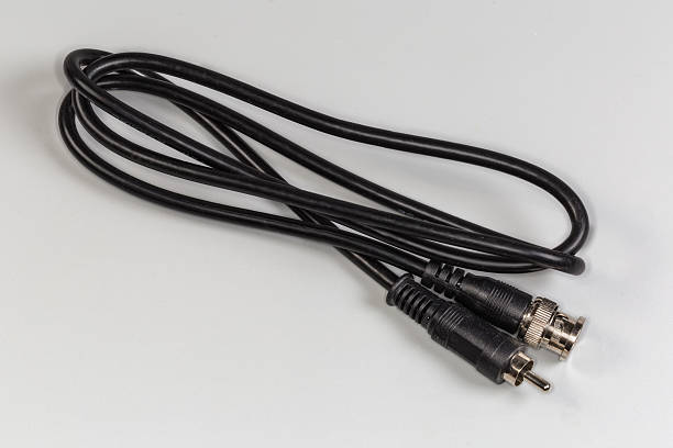 Black cinch audio cable with golden plugs macro on black