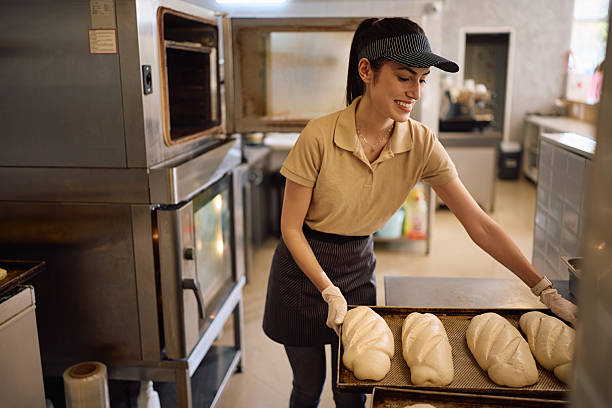 istock Young happy woman baking bread while working in a bakery. 2212861394