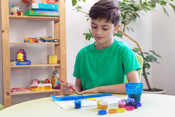 istock Boy painting at home – creative learning activity for kids, childhood development, ADHD, autism support, anti-stress therapy, unplugged time, alternative to screen time, preschool education. 2212862878