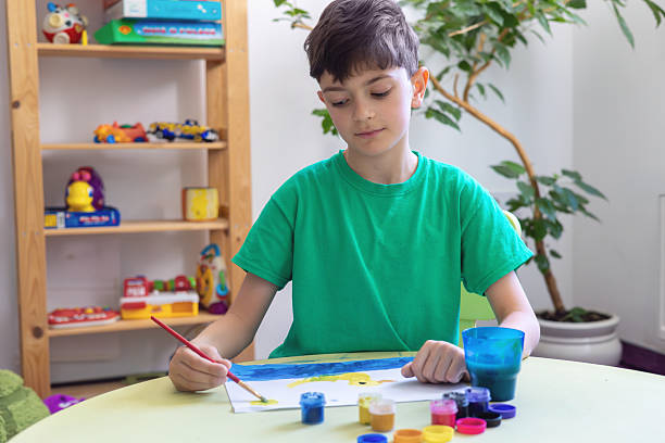 istock Boy painting at home – creative learning activity for kids, childhood development, ADHD, autism support, anti-stress therapy, unplugged time, alternative to screen time, preschool education. 2212862881