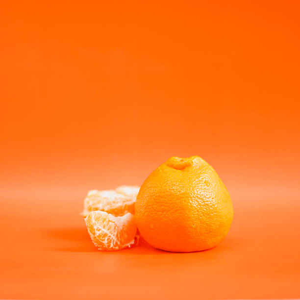 istock Orange. Fresh oranges isolated on orange color background. Still Life. Copy space for your text. 2212862906