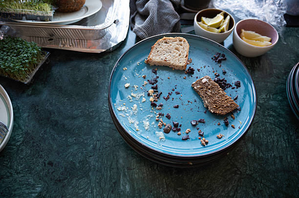 slices of bread and leftovers on plates after a meal, Denmark, April 24, 2025