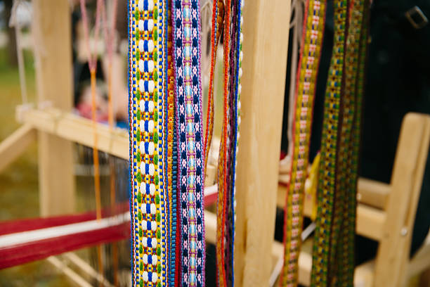 istock Traditional weaving loom with colorful threads outdoors 2212865781