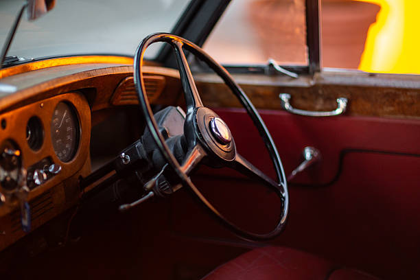 istock Vintage Car Interior with Classic Wooden Dashboard and Wheel 2212865896