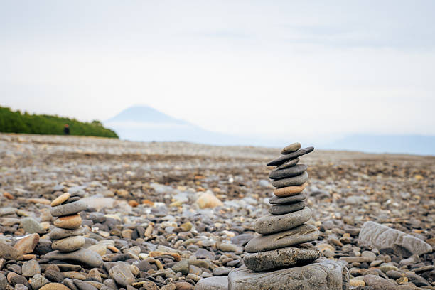Rock stacking on Miho no Matsubara beach with mt Fuji