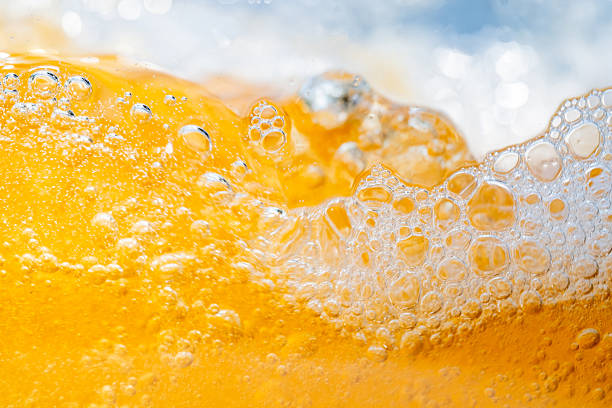istock Close up bright orange Oil or beer splash texture and nature waves, Beautiful waves curve and little bubbles smooth for graphic design and background, Oil Bubbles, Soft beer bubbles, Selective focus 2212881663