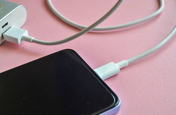 istock Mobile phone being charged using a power bank. 2212882154