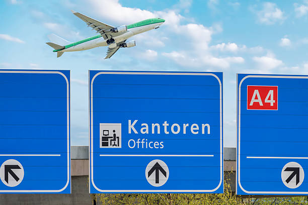 istock Dutch highway route sign to offices with airplane 2212882156