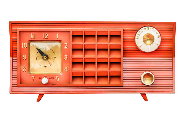 A collection of antique radios stacked against a red brick wall, perfect for retro-themed designs, advertising, and nostalgic concepts.