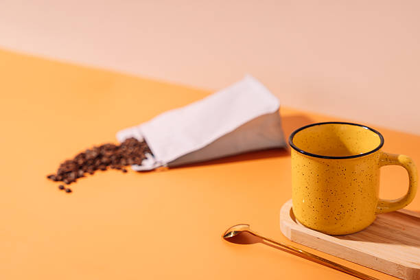 istock Yellow mug with spoon and coffee beans 2212892512