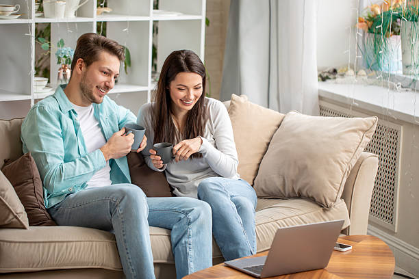 istock Couple enjoying tea time while watching laptop 2212896930