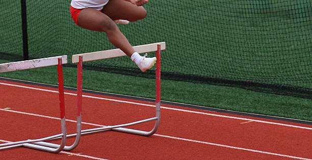 istock Athlete Jumps Over Hurdles During a Track Hurlde Rac3e 2212897019