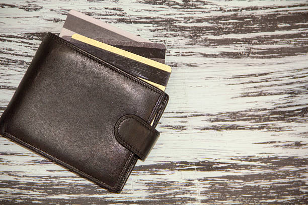 istock leather wallet with credit discount cards. Artistic lighting and vintage processing. grunge background 2212897097