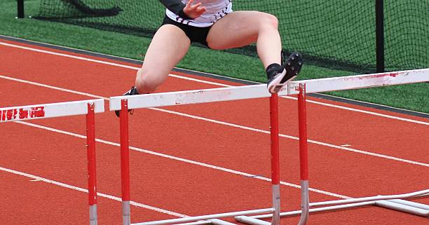 istock One Girl Running in a Track Hurdle Race 2212897123