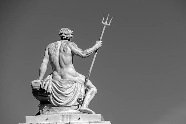 istock Sculpture of Poseidon with Trident in Monochrome Against Clear Sky 2212898627