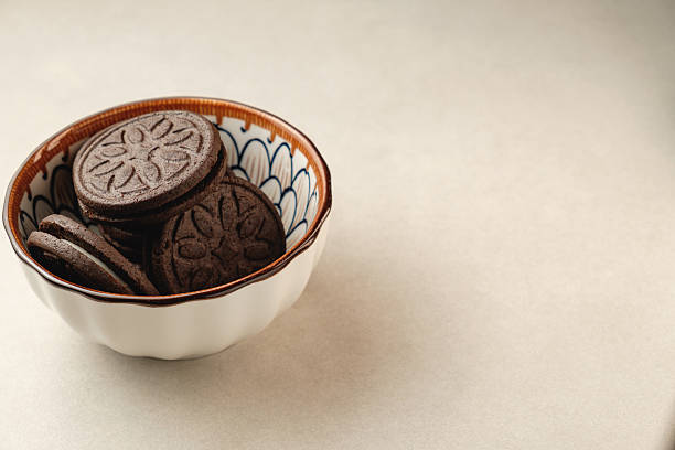 istock Delightful chocolate cookies in a ceramic bowl placed on a simple surface 2212900275