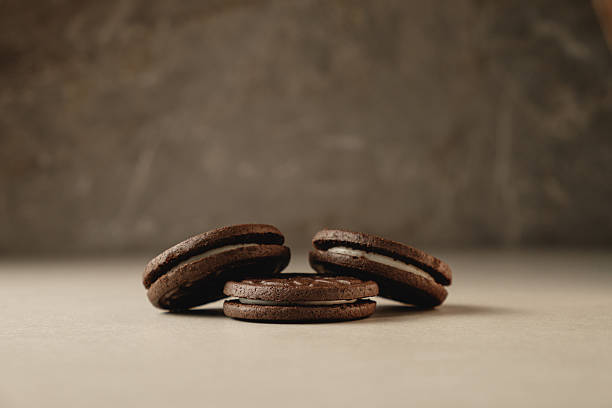 istock Delicious chocolate cookies stacked on a smooth countertop at cozy kitchen 2212900317