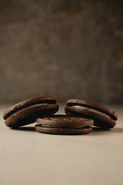 istock Delicious dark chocolate cookies stacked on a rustic surface in warm light 2212900318