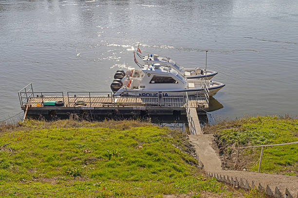 Slavonski Brod, Croatia - October 22, 2024: Two Croatian Police Speed Boats With Double Mercury Outboard Engines Moored at Sava River Floating Dock.