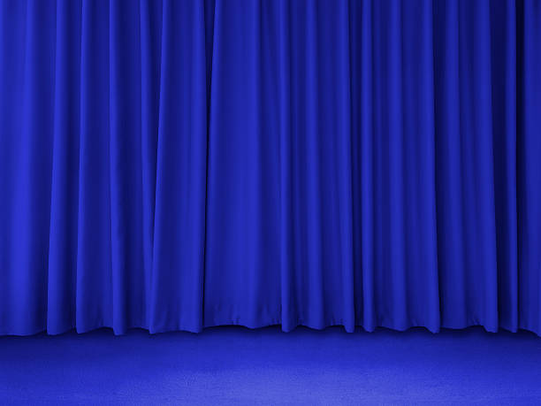 istock Long dark blue curtains on a blue background. 2212903419