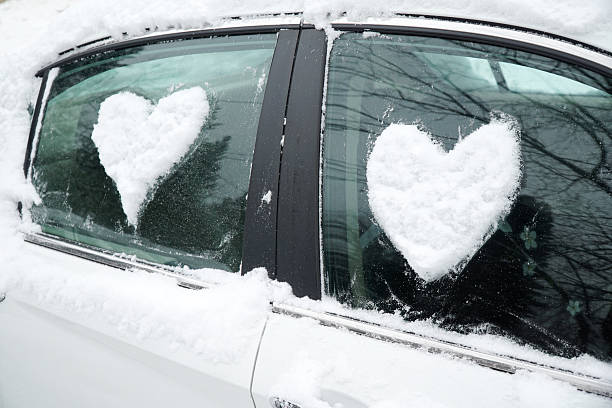 istock snow in heart shape on windshield of the car 2212906537